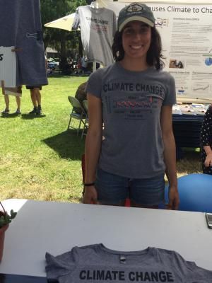 Camille selling her Climate Change T-shirts at the Earth Day festival.